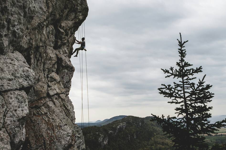 Blogger reviewing climbing gloves on mountain trail