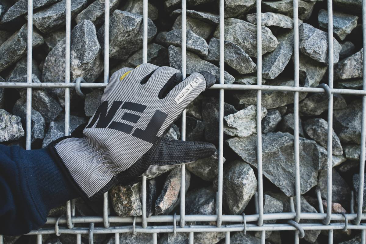 Close-up of rock climbing grip gloves showing silicone grip patterns on palms