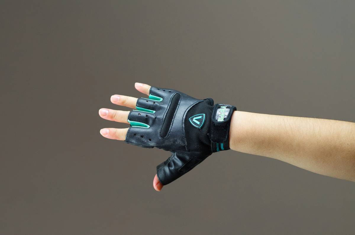 Close-up of high-performance exercise hand weight gloves showing segmented weight design and breathable palm